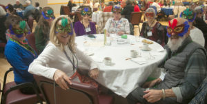 A table of masked players facnig the camera